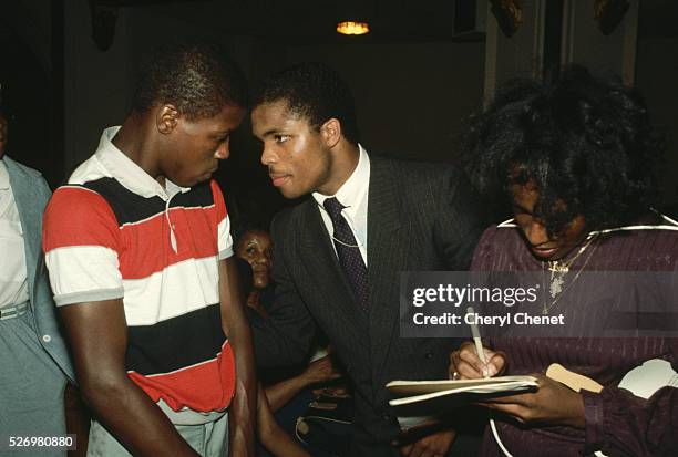 Jesse Jackson, Jr. , son of civil rights leader and two-time presidential candidate Jesse Jackson, talks with a young man at a voter registration...