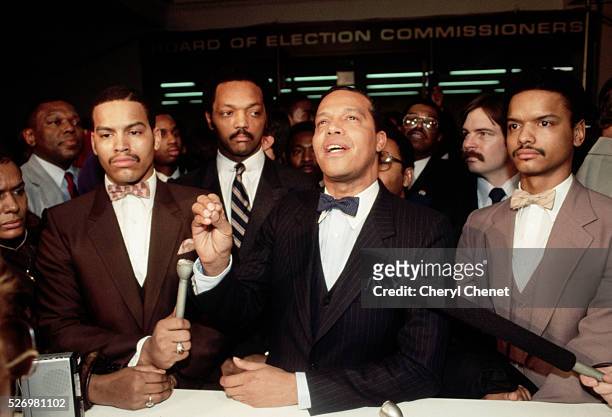 Jesse Jackson , Baptist minister and candidate for the Democratic presidential nomination in 1984, looks on as Minister Louis Farrakhan and his...