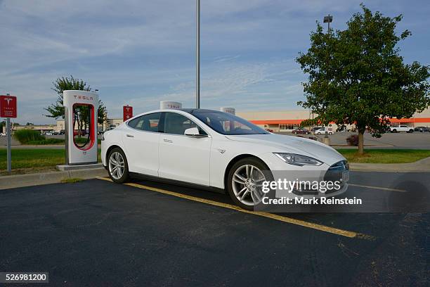 Topeka, Kansas 9-5-2015 Tesla Model S is plugged in and charging at the supercharger station in the Arby's parking lot in Topeka Kansas. Tesla...