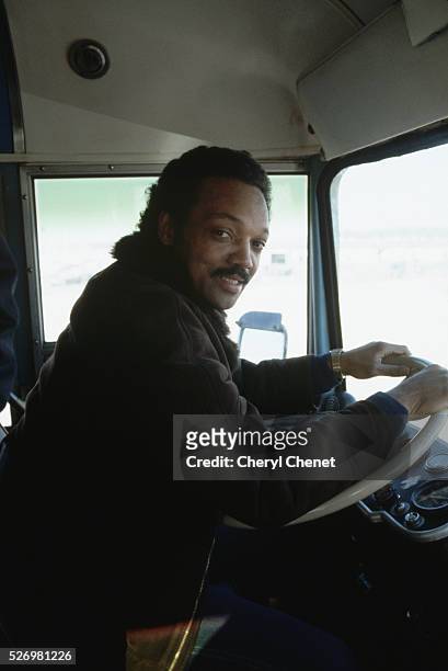 Jesse Jackson, Baptist minister and candidate for the Democratic presidential nomination in 1984, playfully commandeers the driver's seat of the...