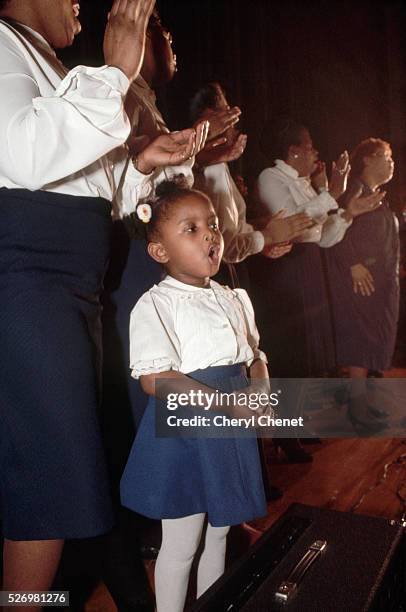 Young girl sings along with a gospel choir at a rally for presidential hopeful Jesse Jackson.
