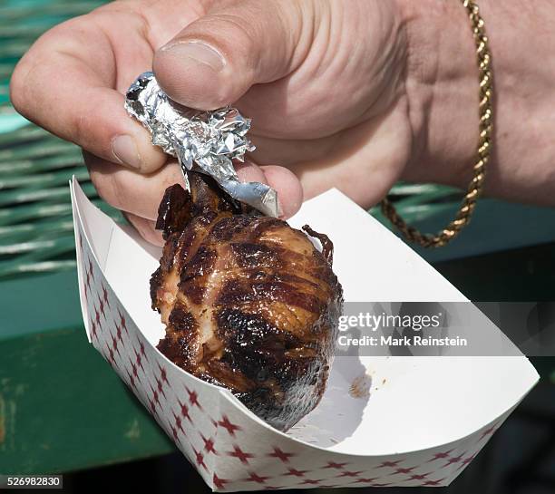 Hutchinson, Kansas. 9-19-2015 Bacon wrapped Chicken lollipop is one of the big snack treats at the State Fair. Credit: Mark Reinstein