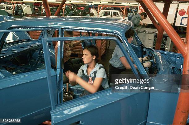 Workers assemble a Zhiguli car, a revised version of the Fiat 124, at an auto factory in Togliatti. The factory was designed and built by Fiat of...