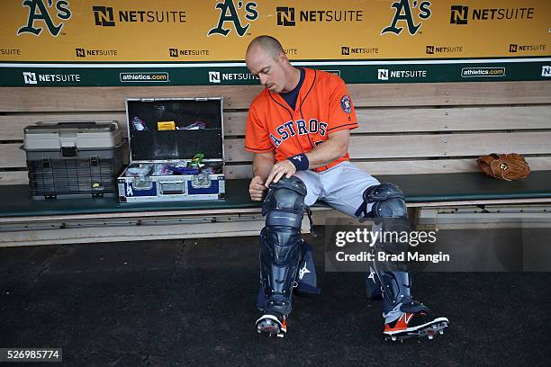 Erik Kratz of the Houston Astros gets ready in the dugout before the game against the Oakland Athletics at the Oakland Coliseum on Friday, April 29,...