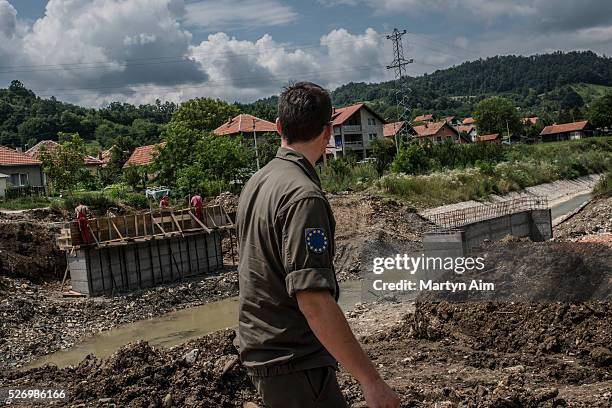 First Lieutenant Thomas Fuchs, an Austrian Army engineer serving with EUFOR, surveys the progress of a bridge building project near Tuzla in Bosnia...