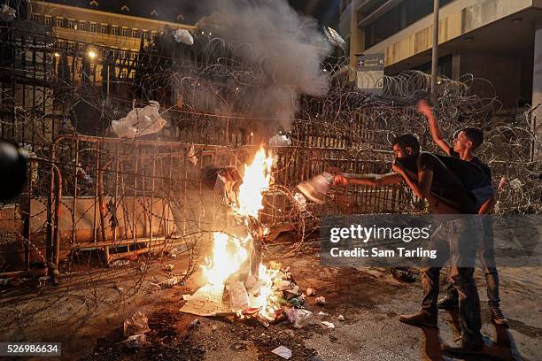 Demonstrators burn garbage outside the Serail, the main government headquarters, in downtown Beirut, Lebanon as part of the ongoing "YouStink"...