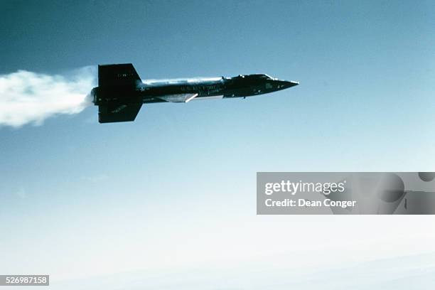 The X-15 leaves a thick contrail as it streaks over Edwards Air Force Base in California, during a test flight. The X-15 rocket plane, built by North...