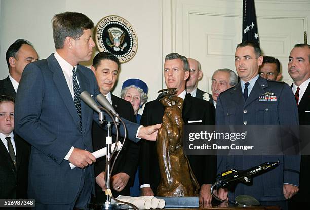 Test pilots of the X-15 rocket plane watch as President John F. Kennedy awards the Harmon International Trophy to NASA at the White House. The X-15...