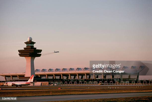Plane takes off behind the terminal at the Dulles International Airport, which was designed by the Finnish-American architect Eero Saarinen.