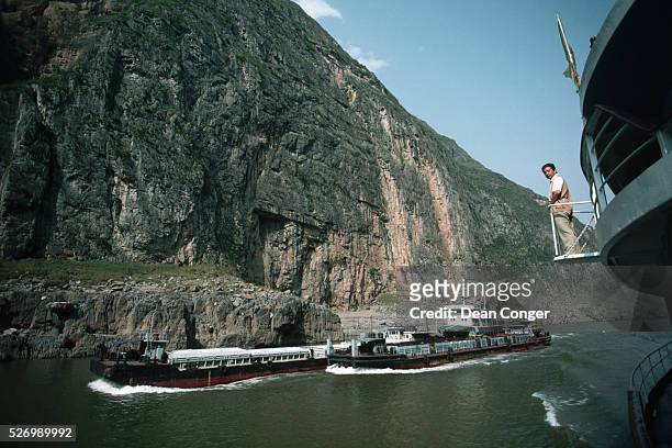 Lookout on a boat watches the distance to passing barges in one of the narrow gorges on the Yangtze River, or Chang Jiang, China's longest.