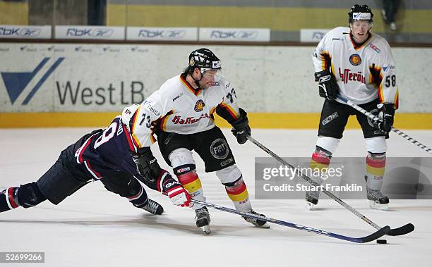 David Legwand of the USA lunges at Tino Boos of Germany during The International Friendly Ice Hockey match between Germany and USA at The Olympic...