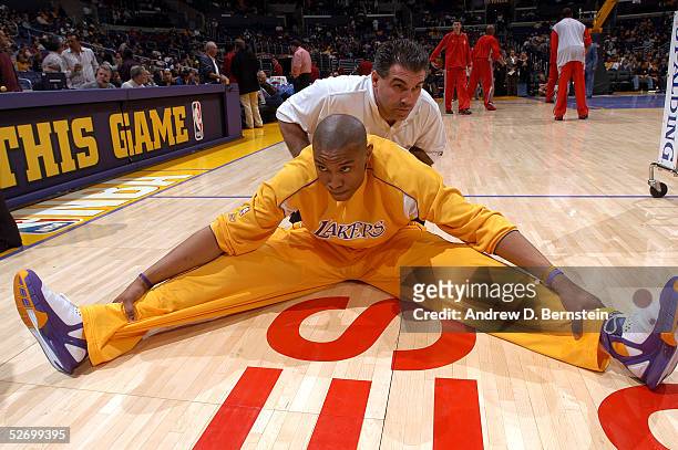 Caron Butler of the Los Angeles Lakers stretches prior to the game against the Houston Rockets on April 7, 2005 at the Staples Center in Los Angeles,...