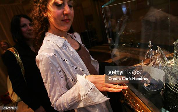 Jenn Harris, a New York actress, holds her hand next to one of the world's largest diamonds at The Wedding Salon bridal show April 26, 2005 in New...