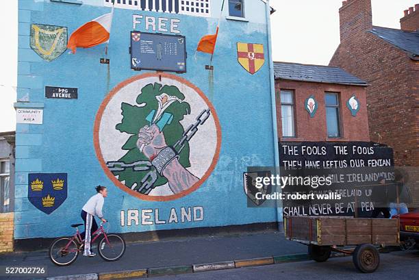 Republican mural on Upper Falls Road in Belfast shows a hand, chained by shackles "Made in Britain," holding a lilly. The Northern Ireland peace...
