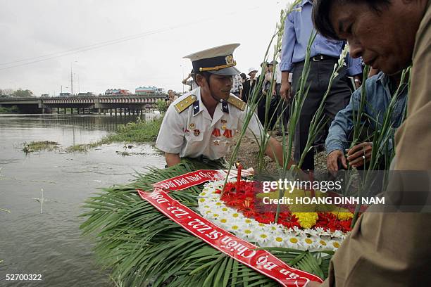 Veterans and officials prepare to throw a wealth into the river 27 April 2005, near to Rach Chiec bridge through which Vietcong tanks entered Saigon...