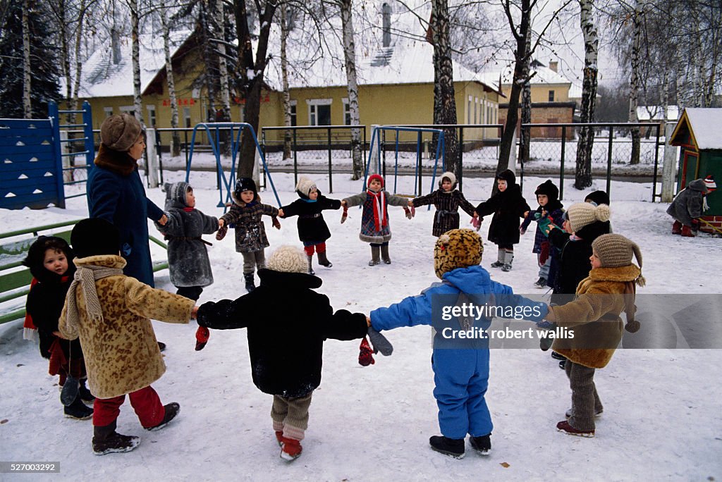 Children Hold Hands in Snow