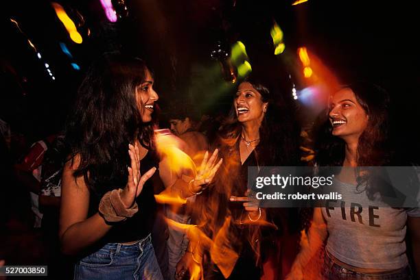 Women at a rave party produced by MTV and Kingfisher beer in a Bangalore warehouse.