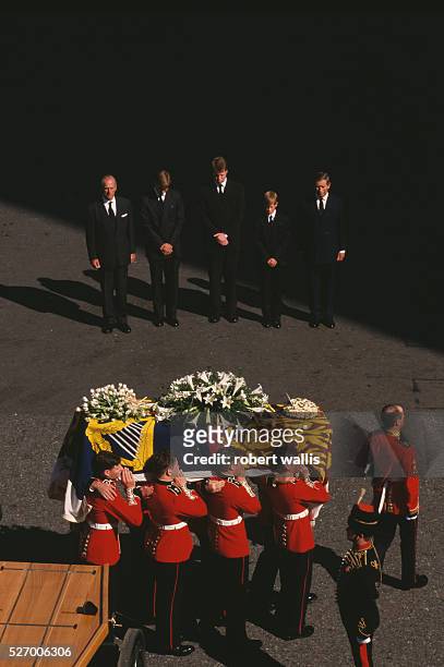 Philip, Duke of Edinburgh, Prince William, Earl Spencer, Prince Harry and Charles, Prince of Wales bow their heads behind Diana's casket during the...