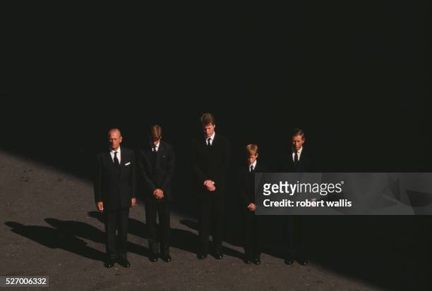Charles, Prince of Wales, Prince Harry, Earl Spencer, Prince William, and Philip, Duke of Edinburgh bow their heads at the funeral of Diana, Princess...