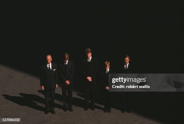 Charles, Prince of Wales, Prince Harry, Earl Spencer, Prince William, and Philip, Duke of Edinburgh bow their heads at the funeral of Diana, Princess...
