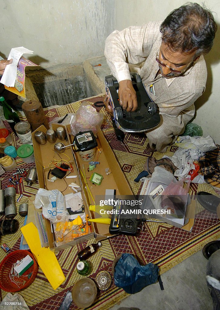 A Pakistani bomb disposal expert examine