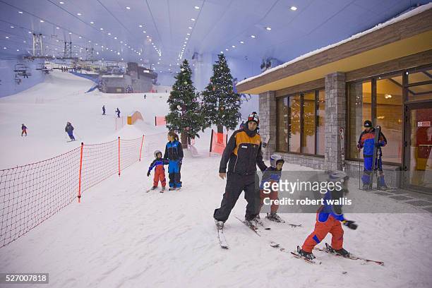 Family skis at Ski Dubai at the Mall of the Emirates, Al-Soufouh, Dubai. Ski Dubai is the Middle East's first indoor ski resort, with five runs and a...