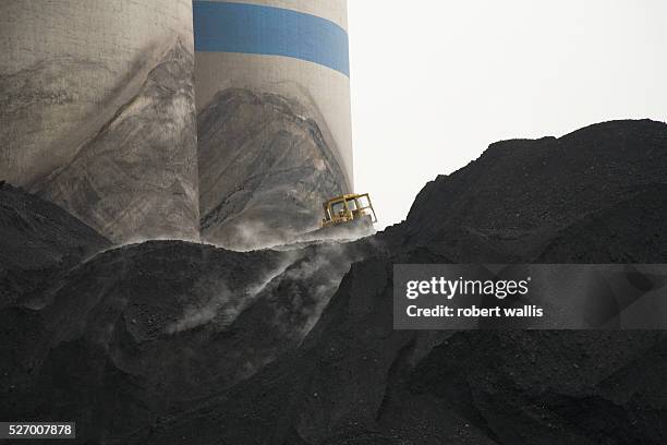 Bulldozer moves coal destined for power stations or for shipment to other parts of China at the Jing Hua-gong coal mine. Shanxi is China's top coal...