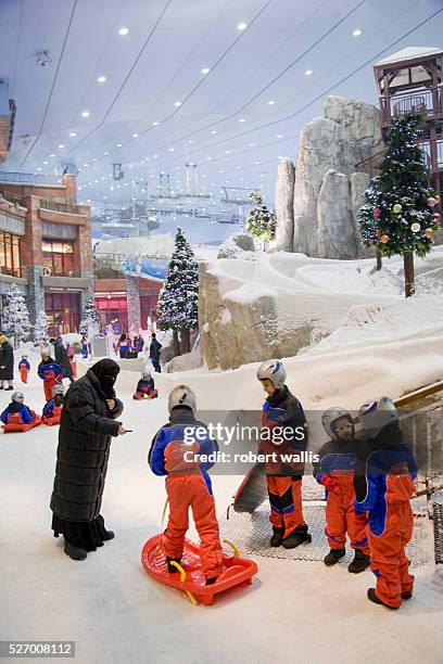 Children play with sleds at Ski Dubai at the Mall of the Emirates, Al-Soufouh, Dubai. Ski Dubai is the Middle East's first indoor ski resort, with...