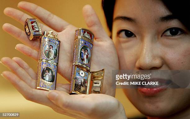 Model holds two 18k gold and enamel snuff bottles with concealed complicated triple automaton and watch, circa 1820 during a press preview at...