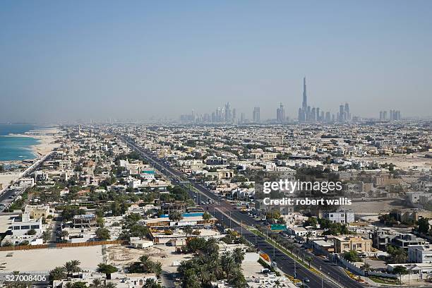 View of Dubai residential areas along Jumeirah Beach with Burj Dubai, the world's tallest building, rising in the background.