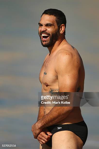 Greg Inglis shares a laugh with a team mate during the Australia Kangaroos Test team recovery session at Coogee Beach on May 2, 2016 in Sydney,...