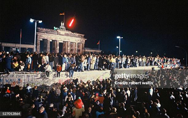 The Berlin Wall in front of Branderburg Gate on the night of November 9th, 1989. Thousands of celebrants climbed on the Wall as news spread rapidly...
