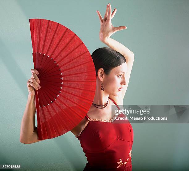woman dancing with fan - flamencos fotografías e imágenes de stock