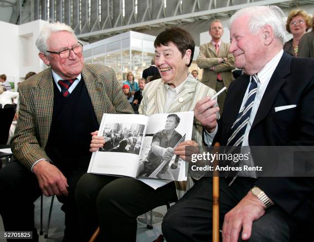 Photographer J.H. Darchinger and Hannelore "Loki" Schmidt presents former chancellor Helmut Schmidt with the book during the opening of the...