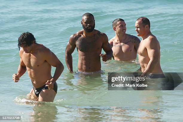 Johnathan Thurston, Semi Radradra, Darius Boyd and Matt Scott walk in the water during the Australia Kangaroos Test team recovery session at Coogee...