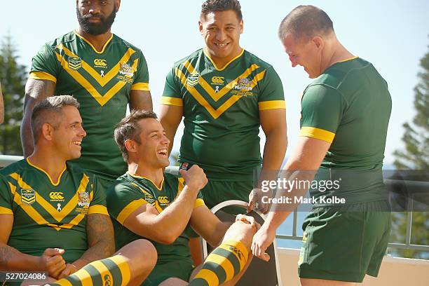 Corey Parker and Cooper Cronk share a joke with Paul Gallen as they ste up for the team photo during the Australia Kangaroos Test team photo session...