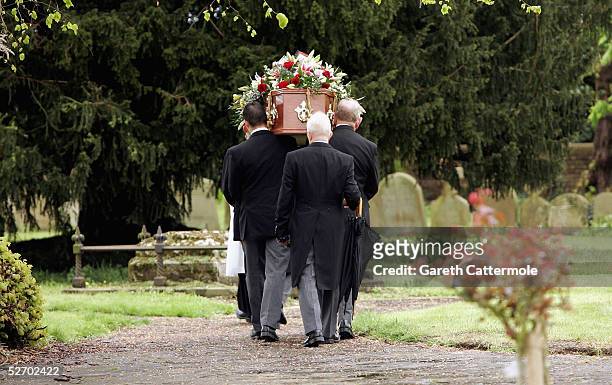 The coffin of Sir John Mills is carried through the grounds of The Parish Church of Saint Mary the Virgin on April 27, 2005 in Denham,...