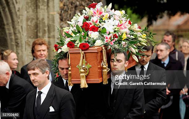 The coffin of actor Sir John Mills is carried through the grounds of The Parish Church of Saint Mary the Virgin during his funeral on April 27, 2005...