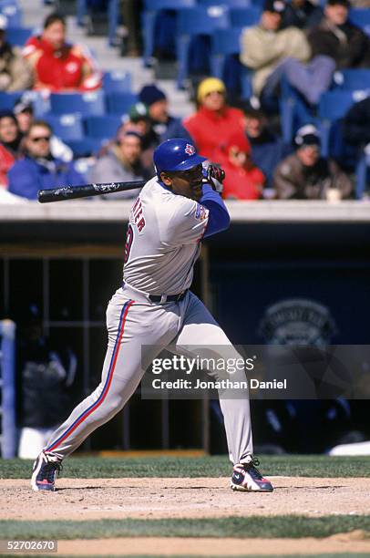 Joe Carter of the Toronto Blue Jays swings at the pitch during the game against the Chicago White Sox at the New Comiskey Park on April 9, 1997 in...