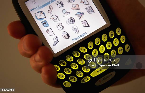 Blackberry device is held April 27, 2005 in New York City. According to the American Society of Hand Therapists, hand held electronic devices, which...