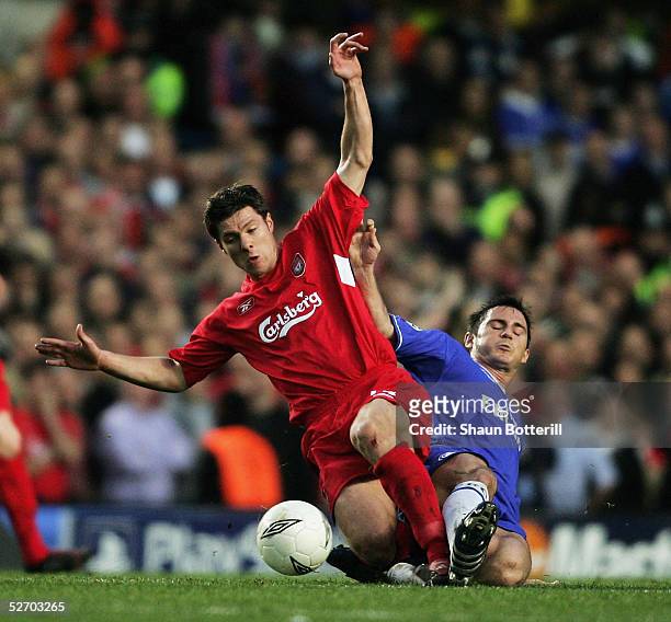Frank Lampard of Chelsea clashes with Xabi Alonso of Liverpool during the UEFA Champions League semi-final first leg match between Chelsea and...