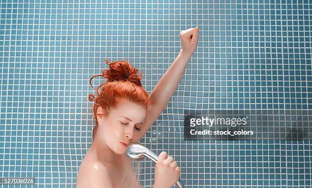 lovely song in my bath - women taking showers stock pictures, royalty-free photos & images