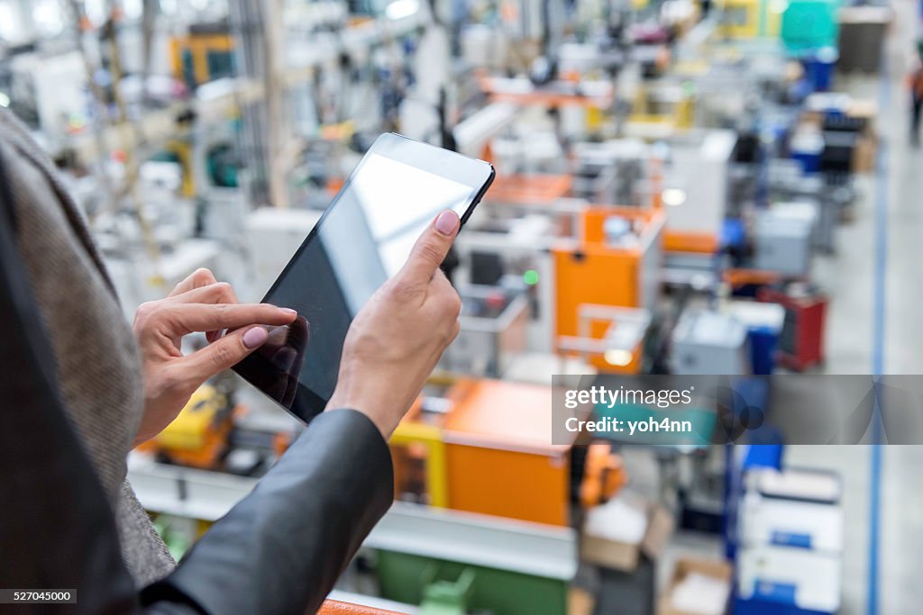 Female manager working on tablet in factory
