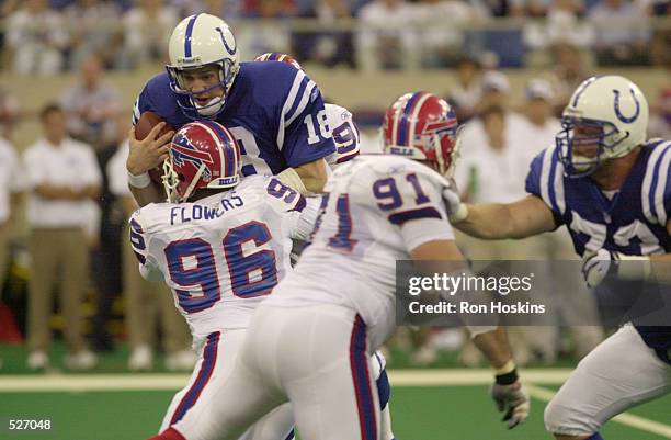 Quarterback Peyton Manning of theIndianapolis Colts is hit by Erik Flowers of the Buffalo Bills during the game at the RCA Dome in Indianapolis,...