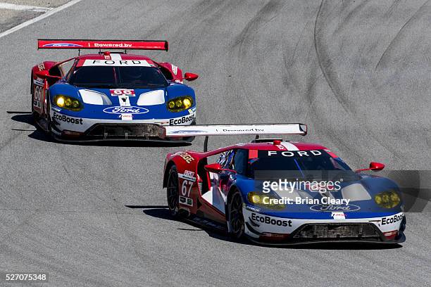 The Ford GT of Ryan Briscoe and Richard Westbrook leads the Ford GT of Dirk Muller and Joey Hand during the IMSA WeatherTech Series race at Mazda...