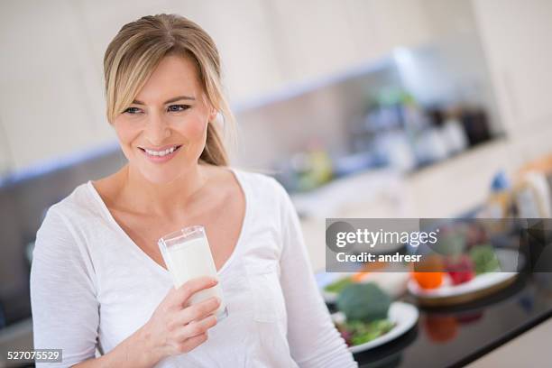 woman with a glass of milk - osteoporosis stock pictures, royalty-free photos & images