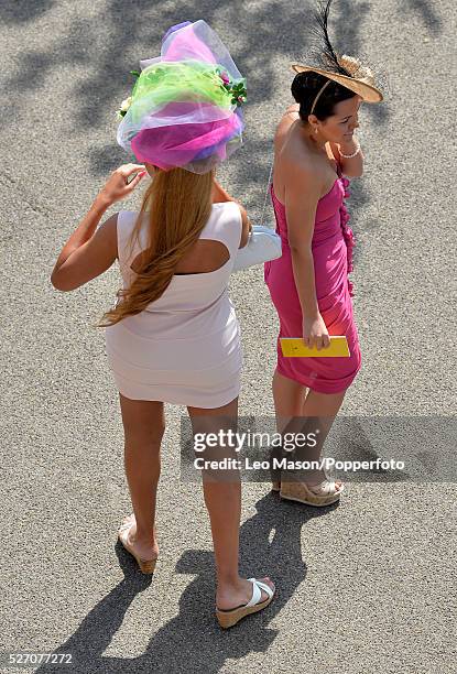 View of two female racegoers attending Ladies Day during the Glorious Goodwood Race of Champions Meeting at Goodwood racecourse in West Sussex,...