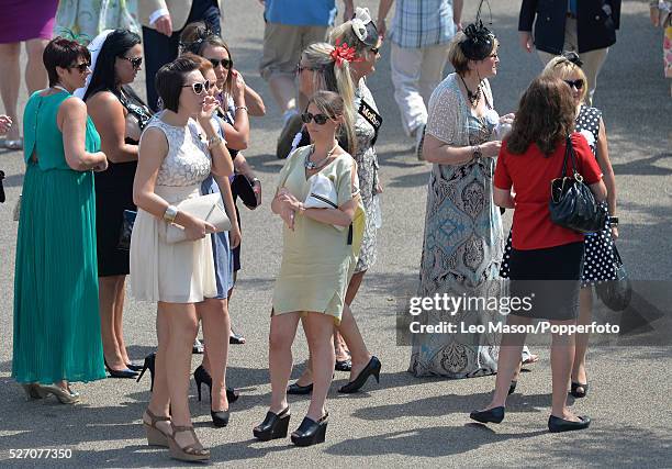 View of a group of female racegoers attending Ladies Day during the Glorious Goodwood Race of Champions Meeting at Goodwood racecourse in West...