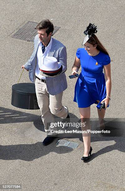 View of a male and female racegoer attending Ladies Day during the Glorious Goodwood Race of Champions Meeting at Goodwood racecourse in West Sussex,...