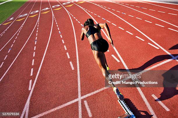 runner taking off from starting block on running track - track and field vintage stock pictures, royalty-free photos & images